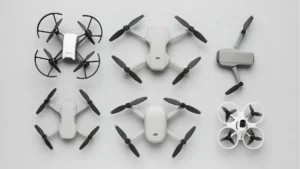 A top view of the best drones for beginners including Ryze Tello, DJI Mini 3, DJI Flip, Potensic Atom SE, DJI Neo, and BetaFPV Cetus X on a neutral background.